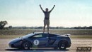 Man sitting on top of Lamborghini Gallardo to celebrate racing victory