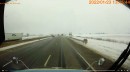 View from a truck as snow plow sends ice, snow, and dirt into oncoming traffic on the opposite lane