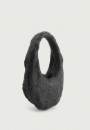 The Coperni Meteroite Swipe is a tote bag carved out of a meteorite