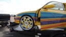 2000s Chevrolet Monte Carlo with Kandy Lime Gold and multi-color graphics rides on matching 26s with LEDs on WhipAddict