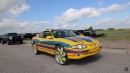 2000s Chevrolet Monte Carlo with Kandy Lime Gold and multi-color graphics rides on matching 26s with LEDs on WhipAddict