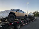 Tesla Cybertruck pickups on a back of a trailer