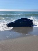 Tesla Model X stuck on the beach fighting the tide