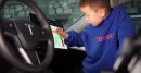 Kid playing with Tesla's UI