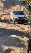 Rivian R1T goes uphill on off-road course