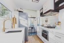The Millennial tiny house has huge kitchen, permanent rooftop patio, and elegant finishes