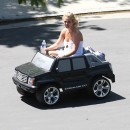 Britney Spears in a mini Cadillac Escalade
