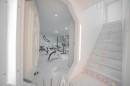 Luxury home is styled like a sterile spaceship in all-white, with prison-like touches here and there