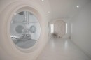 Luxury home is styled like a sterile spaceship in all-white, with prison-like touches here and there
