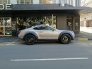Bentley Continental GT with bolt-on fender flares and rooftop-mounted spare wheel