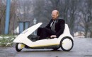 Inventor Sir Clive Sinclair rides around in the ill-fated Sinclair C5 electric trike