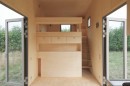 Tiny house opens up to allow natural light to bathe the inside
