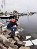 Mackinac Environmental Technology Employee Deploying Oil Pads