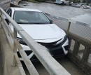 Toyota Camry, stuck on a pedestrian bridge