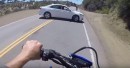 Rider avoids U-turning car