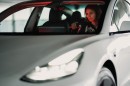 Woman Driving a Tesla Model 3