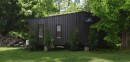 Tiny house with jet-black exterior opens up to reveal a warm interior packed with amenities