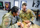 Master Sgt. Chad Hardesty, Ellington Airman Leadership School commandant, and Tech. Sgt. Carmen Turcios Munoz, ALS instructor, compare biometric data from their smartwatches at Edwards Air Force Base, California