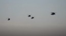 Black Hawk and Apache helicopters in action