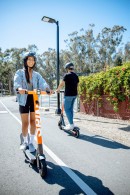 People riding e-scooters