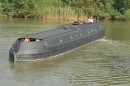 Walhalla is a custom narrowboat that looks menacing but come with an incredibly cozy interior