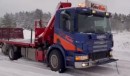 Hyundai Ioniq 5 towing a crane truck stuck in the snow