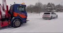 Hyundai Ioniq 5 towing a crane truck stuck in the snow