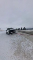 Rivian R1T rescues Ford F-150 Raptor from the snow