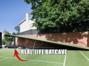 Wayne Residence hides a 12-car garage under the tennis court, styled after the Batcave