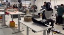 Tesla Optimus bot folding a T-shirt