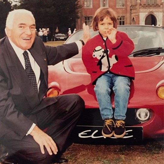 Elisa Artioli sitting on a Lotus Elise with her grandfather, Romano Artioli beside her
