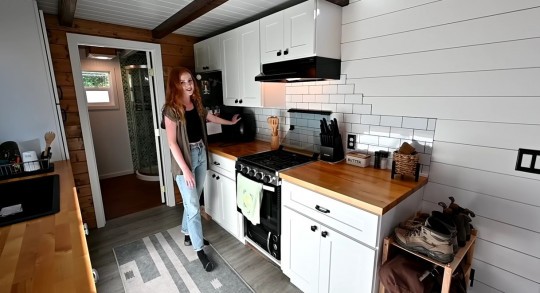 Tiny house with two lofts and a deck mainly built by a young woman and her dad