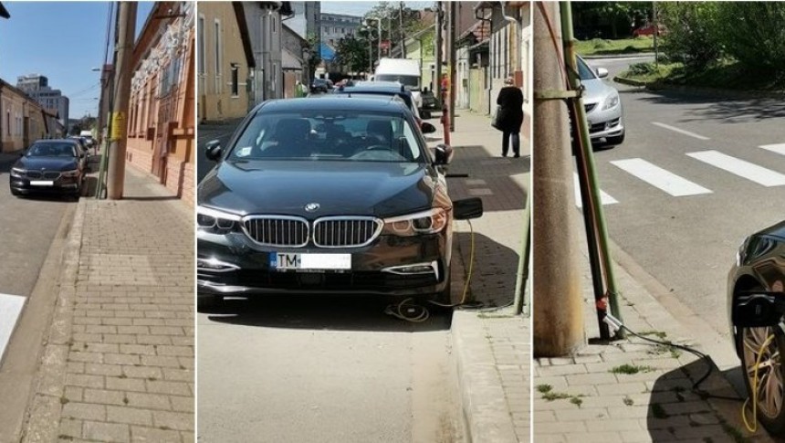 BMW 530e PHEV charging while parked next to an electricity pole, while appearing to be plugged into it