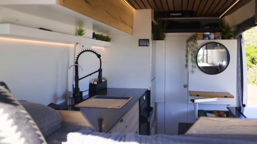 Cozy, Carpenter\-Built Camper Van Boasts a Unique U\-Shaped Kitchen and a Hidden Shower