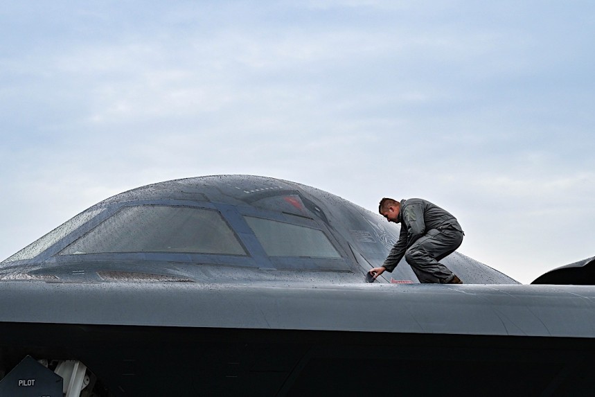 Airman inspecting the fuselage of a B\-2 Spirit