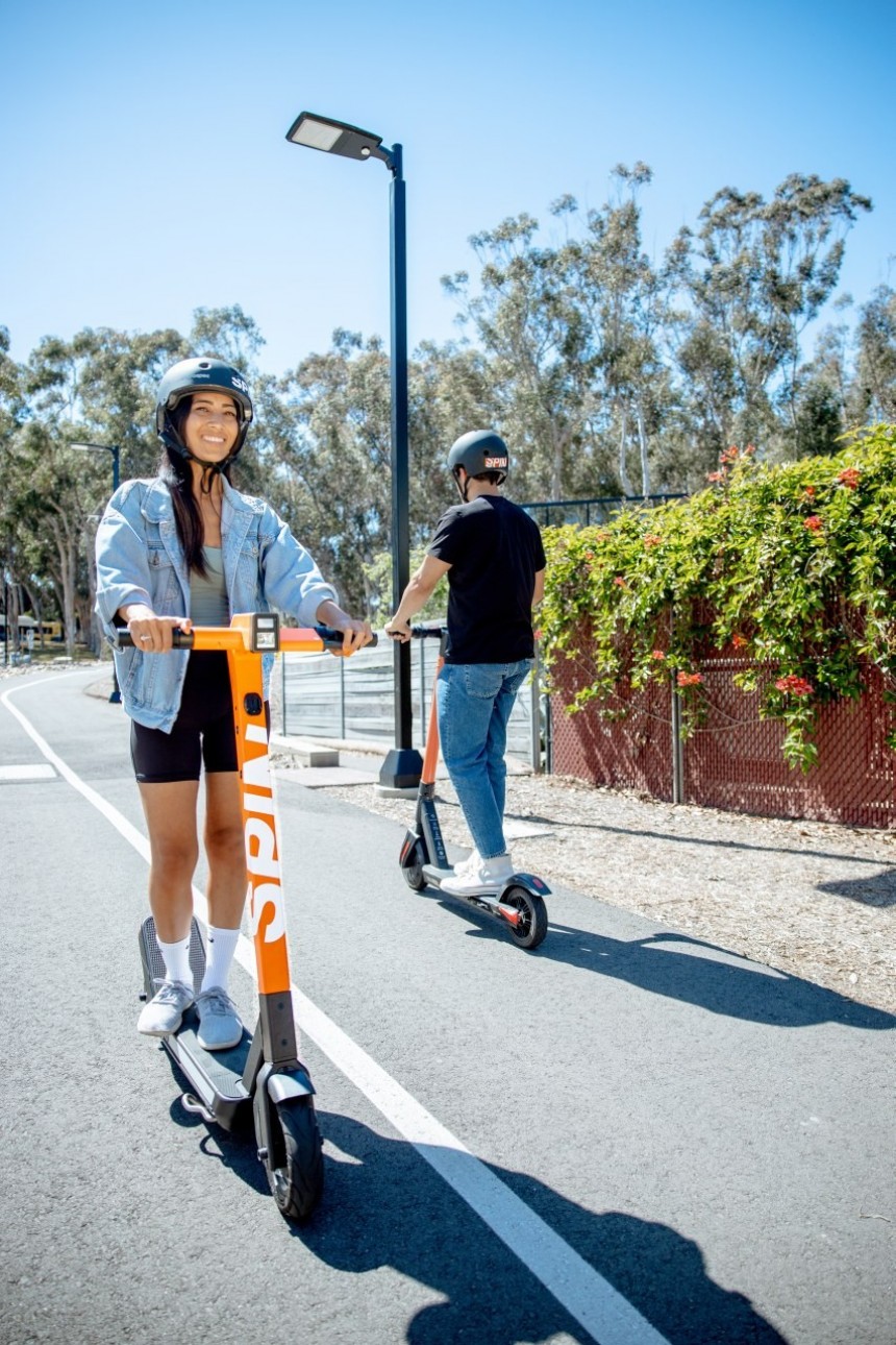 People riding e\-scooters