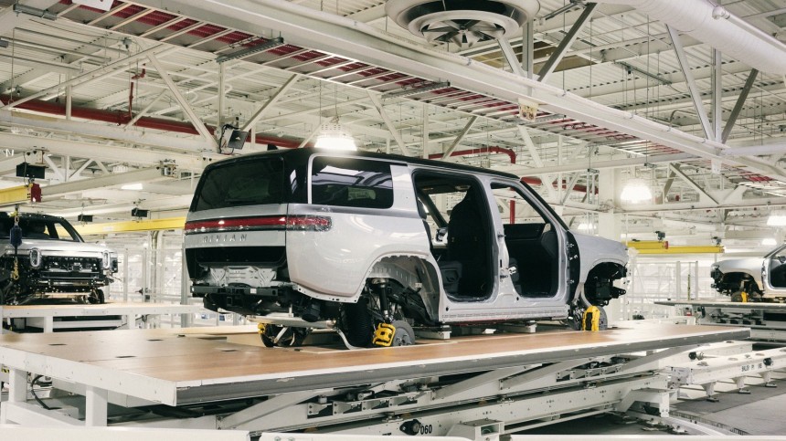 Rivian R1S SUVs being transferred between stations on the trim line in general assembly