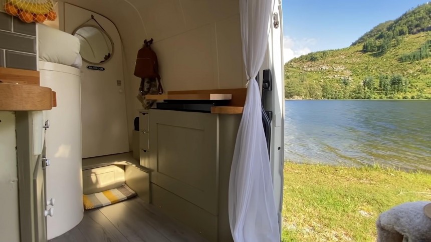Self\-Built Camper Van Is a Unique Apartment on Wheels With an Epic Garage and a Hidden TV