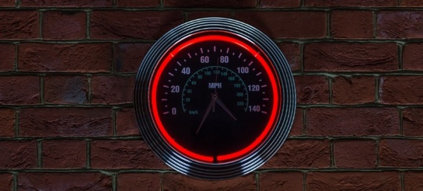 A neon\-rimmed wall clock with a speedometer background