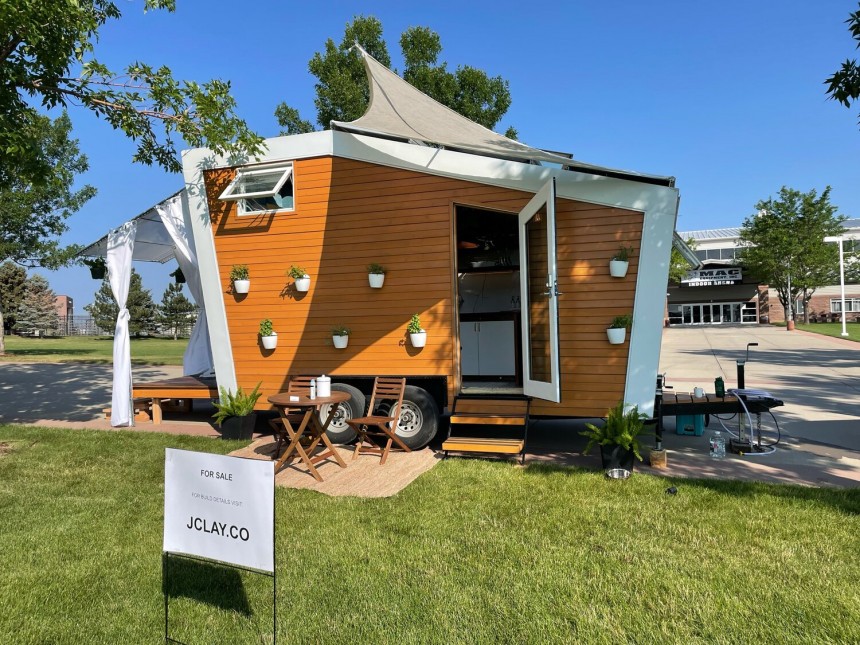 The Longview tiny house has fold\-out deck with awning, two sizable skylights to maximize space