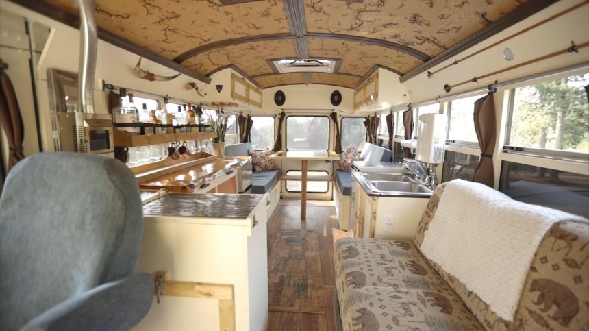 This \$12K Skoolie Has a Unique Cabin Aesthetic With a Wood\-Burned Ceiling and a Custom Bar