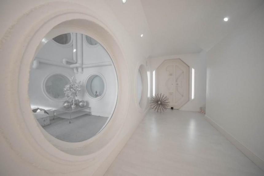 Luxury home is styled like a sterile spaceship in all\-white, with prison\-like touches here and there