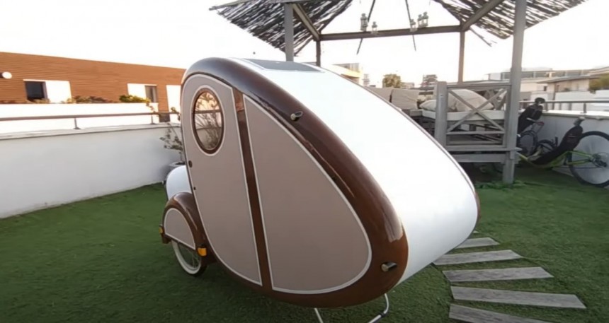 DIY bike trailer doubles as snug bedroom for one adult, has storage, lights, and charging outlets