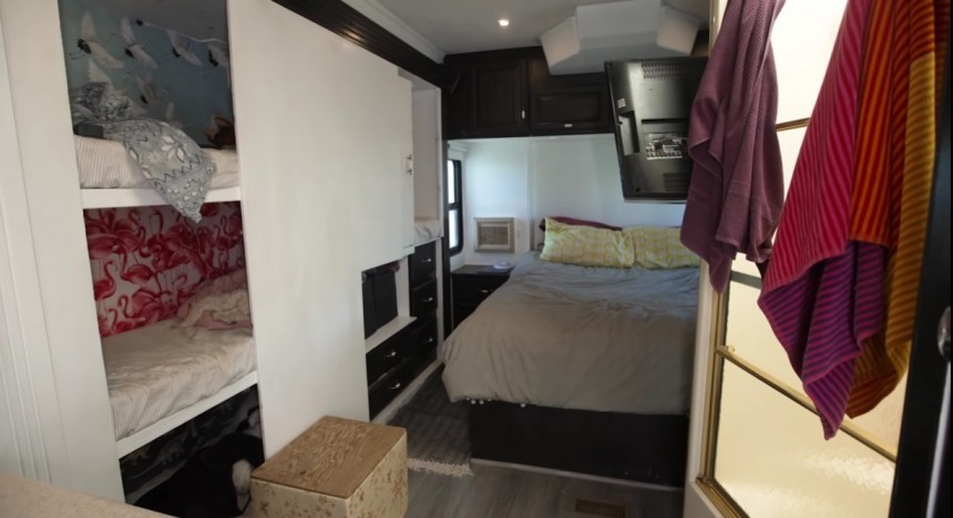 Family of six lives in a 40 ft Class A motorhome that has a separated bathroom and four bunk beds