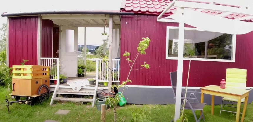 Tiny home has a spacious covered porch in the middle