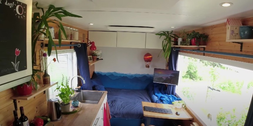 Tiny home has a spacious covered porch in the middle