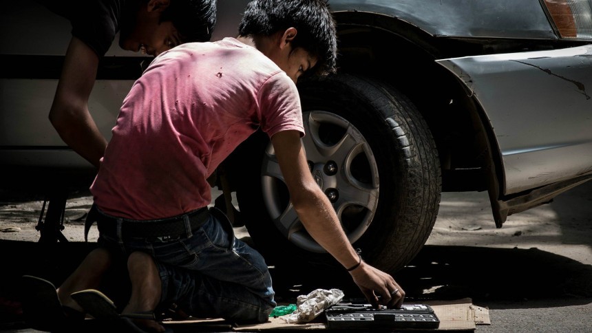 Two Boys Fixing a Tire
