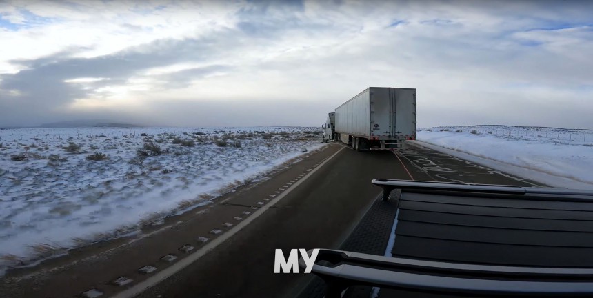 A Rivian R1T Pulling a Semi\-truck Back onto the Road