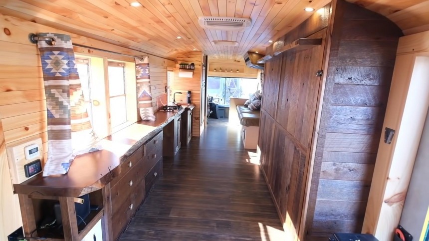 Wheelchair\-Accessible Skoolie Boasts a Rustic Cabin Interior and a Practical Open Layout