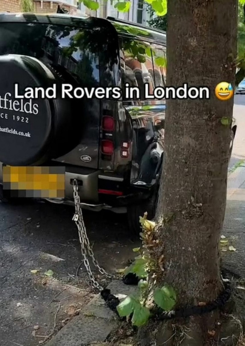 Land Rover is spotted chained to a tree, as if that could deter car thieves